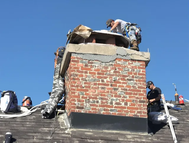 Huntersville Chimney Sweep installing a custom chimney crown in Huntersville, NC