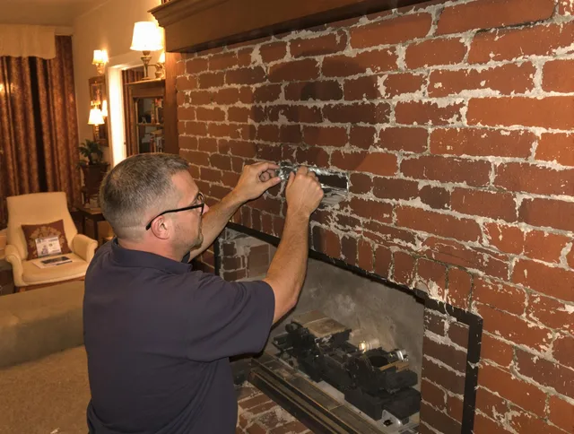 Huntersville Chimney Sweep expert fixing a fireplace in Huntersville, NC